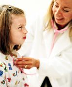 A child receives an exam from her health care provider. Copyright: JupiterImages Corporation