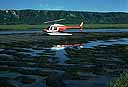 helicopter on rippled half-flooded tidal flats