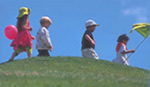 Photo of children playing under a blue sky