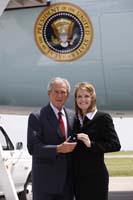 President George W. Bush presented the President's Volunteer Service Award to Ashley Knight upon arrival in Olathe, Kansas, on Thursday, May 29, 2008.  Knight, 25, is a volunteer with Students Take Action and YouthFriends.  To thank them for making a difference in the lives of others, President Bush honors a local volunteer when he travels throughout the United States.  He has met with more than 600 volunteers, like Knight, since March 2002.