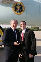 President George W. Bush presented the President's Volunteer Service Award to Andrew Barnhill upon arrival in Greer, South Carolina, on Saturday, May 31, 2008.  Barnhill, 20, is a sophomore at Furman University and a volunteer with Heller Service Corps.  To thank them for making a difference in the lives of others, President Bush honors a local volunteer when he travels throughout the United States.  He has met with more than 600 volunteers, like Barnhill, since March 2002.