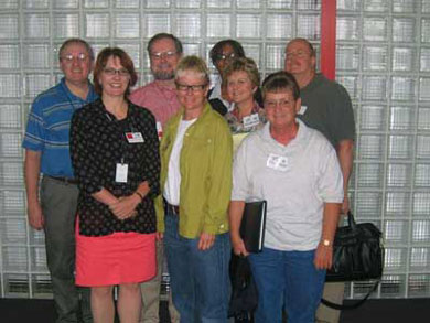 photo of SAMHSA's Kevin Chapman, part of the team deployed to Houston, TX, in the wake of Hurricane Katrina. The team included (l to r) front row: Connie Schlittler, Robin Theuer, Holly Lanmon, Karen Marshall; Back Row:  Mr. Chapman, Thomas Bornemann, SAMHSA's Karen Armstrong, and Brian Baldwin