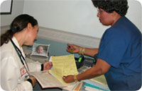 photo of a CASBIRT counselor and doctor conferring about a patient's level of substance abuse