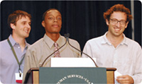 photo of Josh Goldblum and Joshua Cogan standing at the podium at the Spirit of Recovery conference with Benjamin High School senior Jordan Bridges