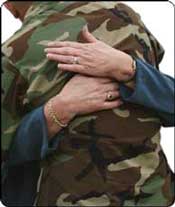 photo of returning veteran hugging family member