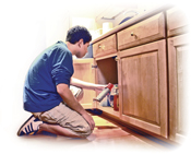 photo of young male teen, kneeling and looking into kitchen cabinet, and holding an aerosol can - click to view report