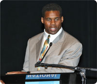 photo of former NFL player Herschel Walker standing behind podium