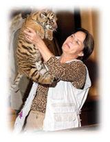woman holding tiger cub