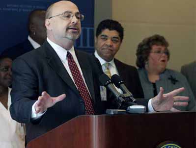 Dr. Timothy Condon addresses the media