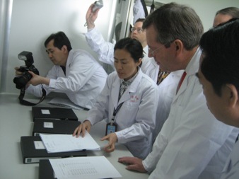 May 15, 2008 – U.S. Secretary of Health and Human Services (HHS) Michael O. Leavitt reviews procedures used to test heparin at the Electrophoresis Laboratory of the National Institute for the Control of Pharmaceutical and Biological Products, part of the State Food and Drug Administration within the Chinese Ministry of Health, in Beijing. (Photo Credit: Bill Steiger, HHS)