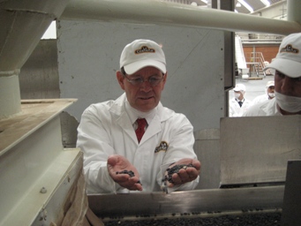 June 23, 2008 – Secretary Mike Leavitt examines dried beans that are about to go through a cleaning process at La Costeña, a food processing plant in Mexico.