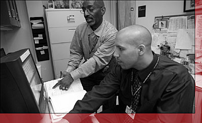 Photo of Two hospital staff members mining through data.