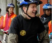 Acting Surgeon General Steven K. Galson rides a bicycle in a group of young people at the Bicycle Transportation Alliance event in Portland, OR.