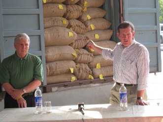 January 9, 2008 – HHS Secretary Michael O. Leavitt refers to a shipping container full of spices destined for the United States during a visit to AVT McCormick Ingredients, Private Limited, in Cochin, India. He is joined by the Commissioner of the HHS Food and Drug Administration, the Honorable Andrew von Eschenbach, M.D.