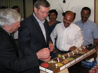 January 9, 2008 – HHS Secretary Michael O. Leavitt (center) and HHS/FDA Commissioner Andrew von Eschenbach (left) examine extracts made from spices at Synthite Industrial Chemicals, Limited in Cochin, India. To the right of Secretary Leavitt is Aju Jacob, Director of Synthite Industrial Chemicals, Limited.