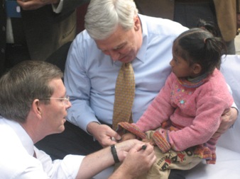 January 11, 2008 – U.S. Secretary of Health and Human Services (HHS) Michael O. Leavitt marks the finger of a young child he has just vaccinated against polio, during a National Immunization Days event at the Sriniwaspuri Maternal and Child Welfare Center in New Delhi, India. Holding the child is the Honorable Andrew von Eschenbach, M.D., Commissioner of the HHS Food and Drug Administration.
