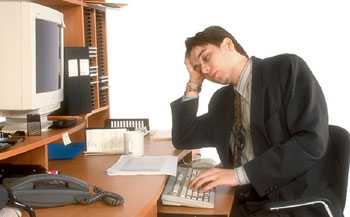 Photo of man sleeping at his desk at work