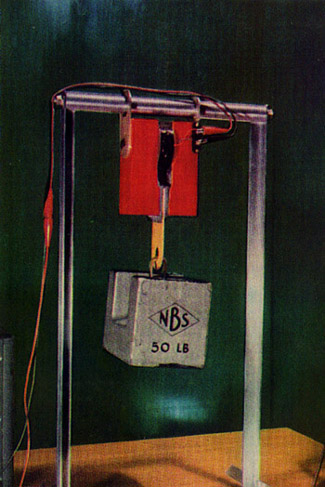 photo of electromagnet and iron particles supporting 50 lb. weight