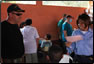 Photo thumbnail: CAPT Dean Coppola discusses standard dental practices with the dental clinic patients and providers at the Escuela Santa Isabel in Escuintla in the Republic of Guatemala.