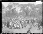 a crowd of people in a clearing