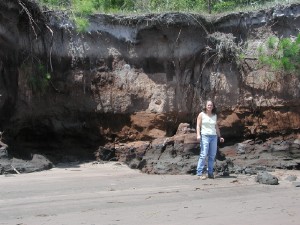 USGS scientist examining an outcrop of organic-rich sediment that drives sustainable natural attenuation of a chlorinated-solvents plume in the ground-water system underlying Kings Bay, GA