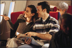 Photo: Airplane passengers looking out of the window