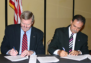 L-R OSHA Assistant Secretary Edwin G. Foulke, Jr. and Mark Baker, President - NMSA sign national Alliance agreement on June 23, 2006