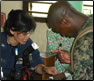 photo thumbnail: CAPT Josephina Souza, a physician, conducts a patient interview at a Pacific Partnership medical civic action program at Buldon Central Elementary School. 