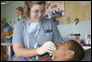 Photo thumbnail: LCDR Lisa Starnes treats a patient in Manta, Ecuador.