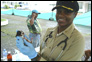 Photo thumbnail: CDR Elvira Hall-Robinson with an 8-day old puppy.