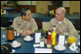 Photo thumbnail: Acting Surgeon General RADM Kenneth P. Moritsugu and CAPT Bruce Boynton, Commanding Officer – USNS Comfort, have a post-breakfast discussion.