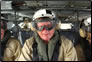 Photo thumbnail: CAPT Craig Shepherd, Officer in Charge, aboard a helicopter.