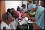Photo thumbnail: Dentist CAPT Angel Rodriguez-Espada examines teeth in Port-au-Prince, Haiti.