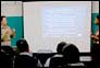 Photo thumbnail: Physician CAPT Louisa Chapman presents the slide, “What is a newly emerged strain of flu? Influenza Viruses & Antigenic Change” at a training in Port-au-Prince, Haiti.