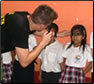 Photo Thumbnail: LCDR Paul DeWitt, an optometrist, evaluates local school children while at the Escuela Santa Isabel in Guatemala.