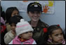 Photo Thumbnail: LT Elizabeth Leavitt, a health services officer with the Mayor of Huara, Peru, and many pediatric patients.L 