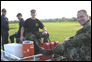 photo thumbnail: CDR John Moroney assists with moving supplies.