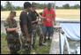 photo thumbnail: LCDR Stephen Piontkowski, LCDR Edward Dieser, and LT Nazmul Hassan at a water system assessment.