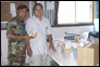 photo thumbnail: LT Nazmul Hassan with the general manager of a coconut oil factory; holding a bar of coconut soap made from coconut meat.