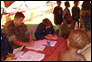 photo thumbnail: Captain Kathleen Downs, officer in charge, registers patients at Bunabun, Papua New Guinea.
