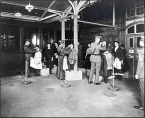 A PHS physician at Ellis Island inspects an immigrant for trachoma, which entailed inverting the eyelid with a buttonhook, early 20th century. Photo courtesy of the National Library of Medicine.