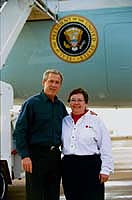 President George W. Bush met Suellen Mayberry upon arrival in San Diego, California, on Tuesday, November 4, 2003. Mayberry, an active volunteer with the American Red Cross, helped establish and relocate an emergency shelter for individuals and families forced to evacuate their homes due to recent California wildfires.