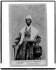 Photograph of Sojourner Truth, three-quarter length portrait, standing, wearing spectacles, shawl, and peaked cap, right hand resting on cane, courtesy of the Library of Congress, Prints and Photographs division