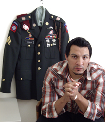 photo of former Army Sgt. Abel Moreno with uniform behind him