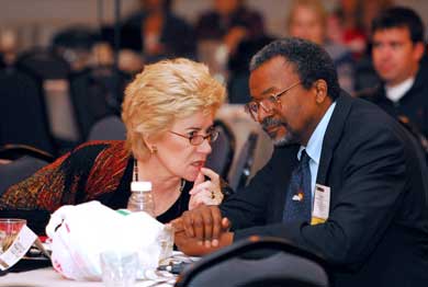 photo of A. Kathryn Power, Director of SAMHSA's Center for Mental Health Services (left), and Dr. H. Westley Clark (right), Director of SAMHSA's Center for Substance Abuse Treatment, conferring before a joint conference presentation