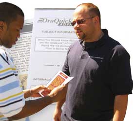 photo of two men examining brochure with other brochures in background