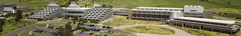 Photo of NREL research buildings on the South Table Mountain site. The Field Test Laboratory Building is on the far left, the Solar Energy Research Facility is in the center, and the Science and Technology Facility is on the far right.