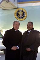 President George W. Bush met Anthony Calhoun upon arrival in Chicago, Illinois, on Tuesday, January 7, 2003. Calhoun, a Chicago native, volunteers each week as a mentor for students in the Chicago area.