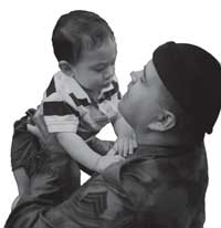 photo of vet holding his infant son