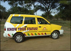 Photo: A car promoting HIV awareness with "Know Your Status!" written on the side.